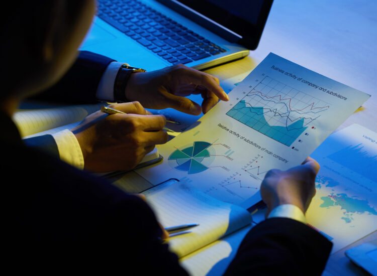 Hands of business executives analyzing company activity